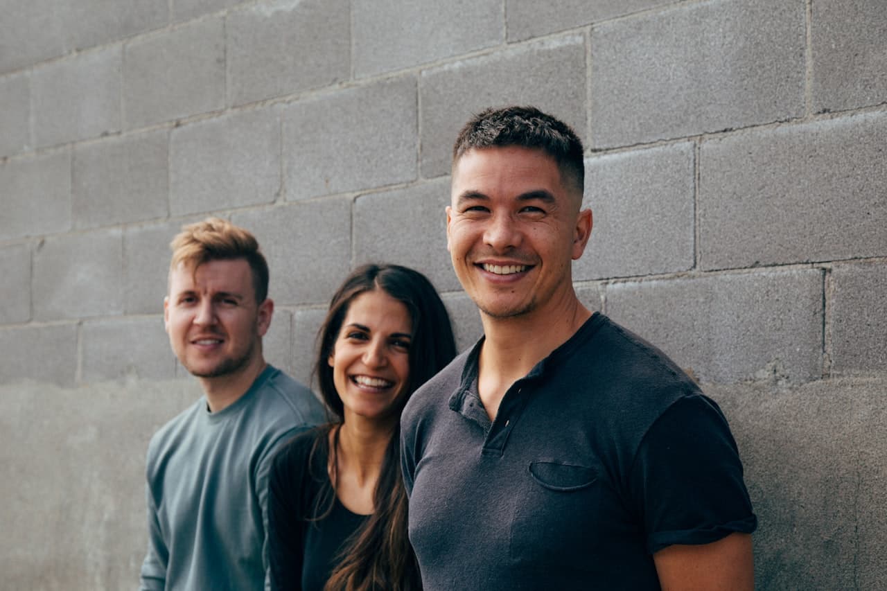 Members of the Seety team smiling together in front of a wall